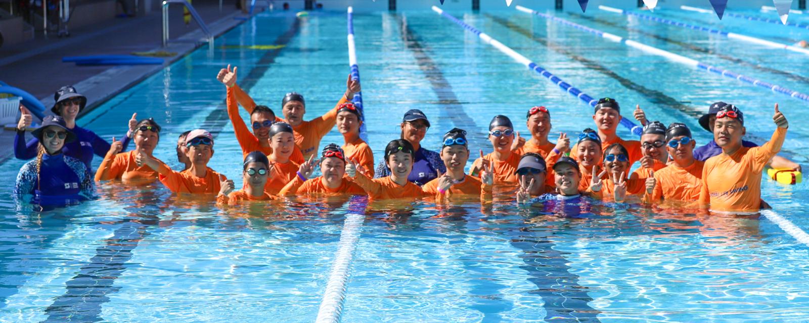 Students learn to swim in a pool