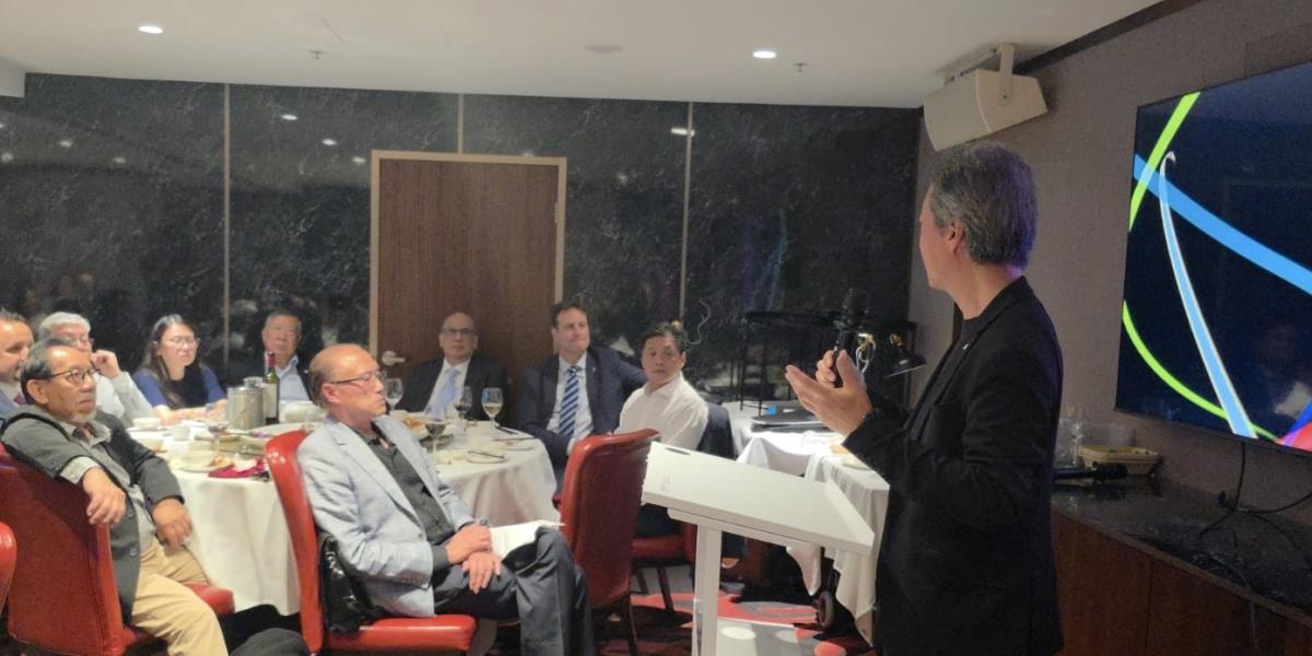 a man in front of a crowd 