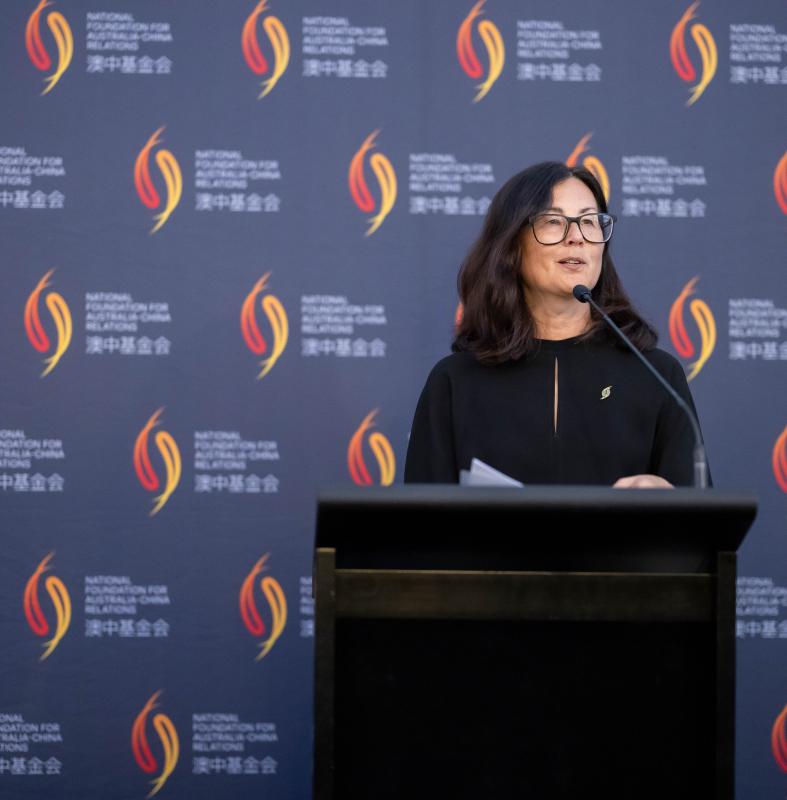 Marina Go at lectern