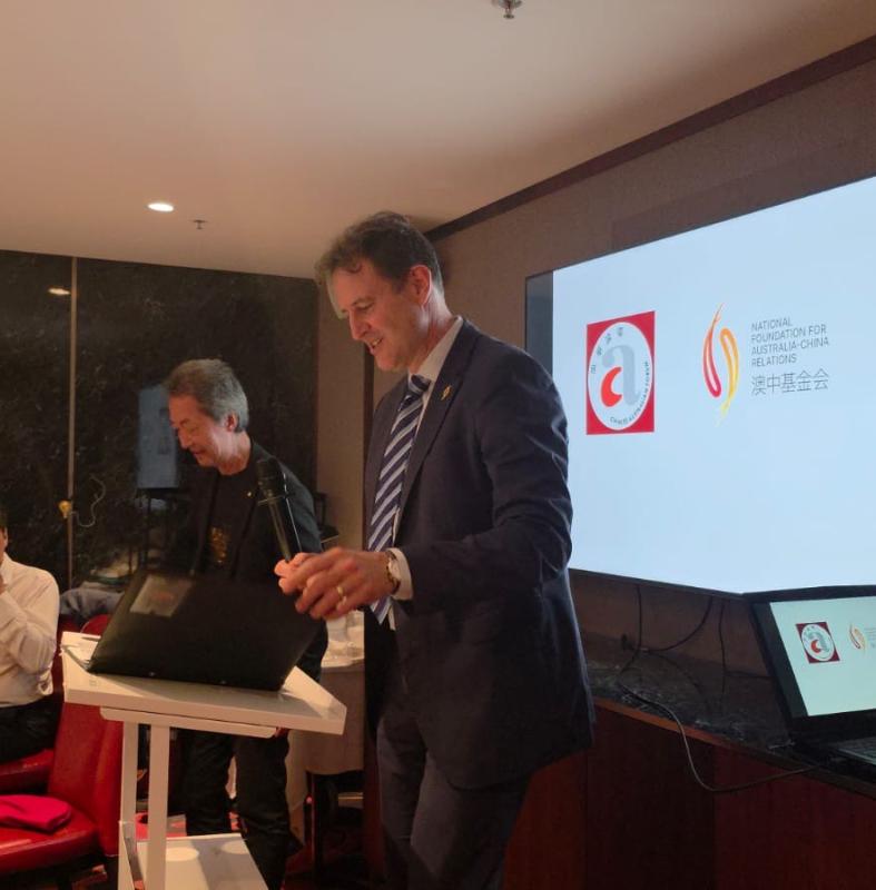 two men in front of a screen 