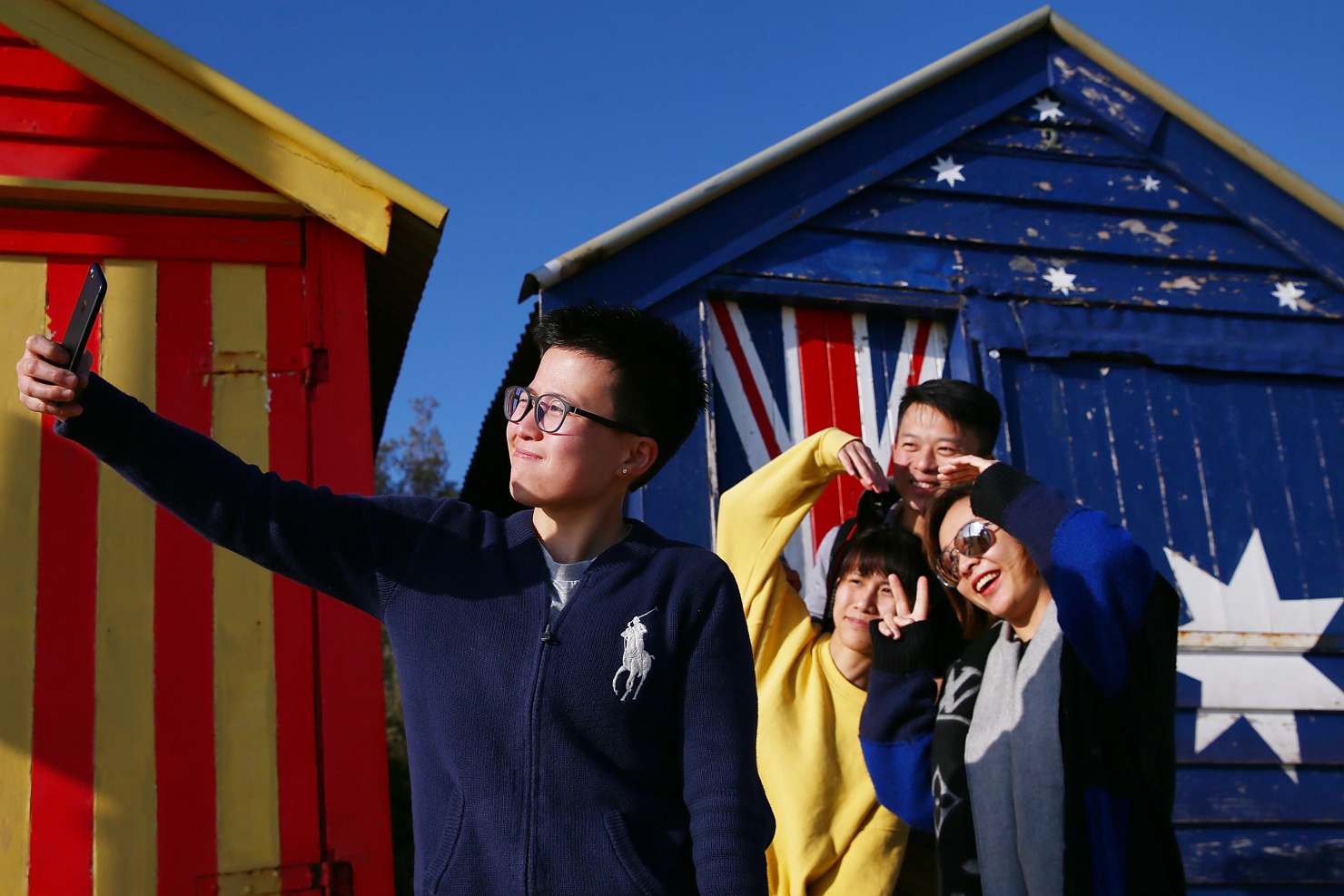 Tourists take photos at the bathing boxes on Brighton Beach in Melbourne, Victoria. Photo: Michael Dodge/Getty Images